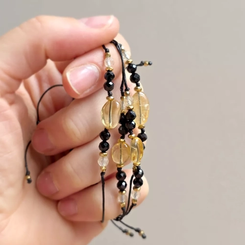 Minimalistyczna bransoletka z cytrynem, czarnym turmalinem i hematytem na czarnym sznurku. Naturalna biżuteria wspierająca ochronę, pewność siebie, radość i ugruntowanie.